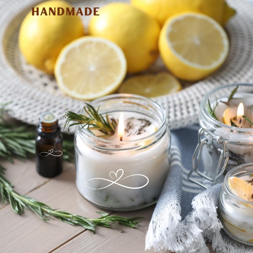 Handmade candles with lemons and essential oil on a wooden surface