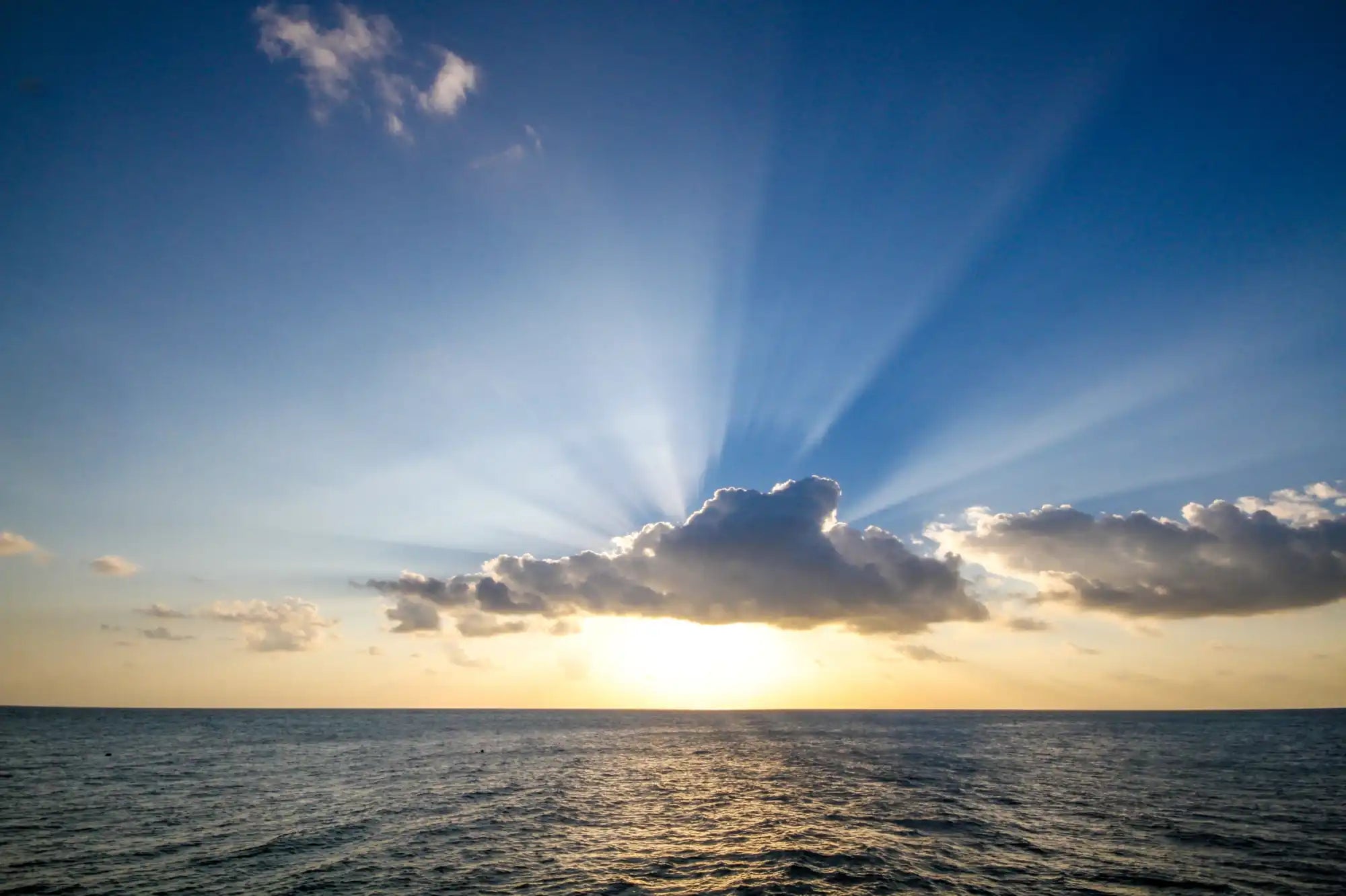 A dramatic ocean sunset with crepuscular rays.