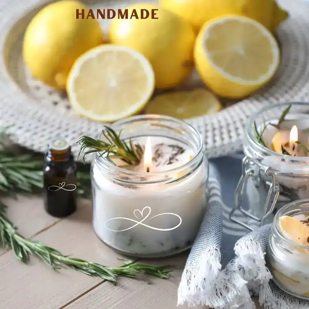 A lit, handmade candle in a clear glass jar, infused with rosemary and a heart-shaped infinity symbol design.