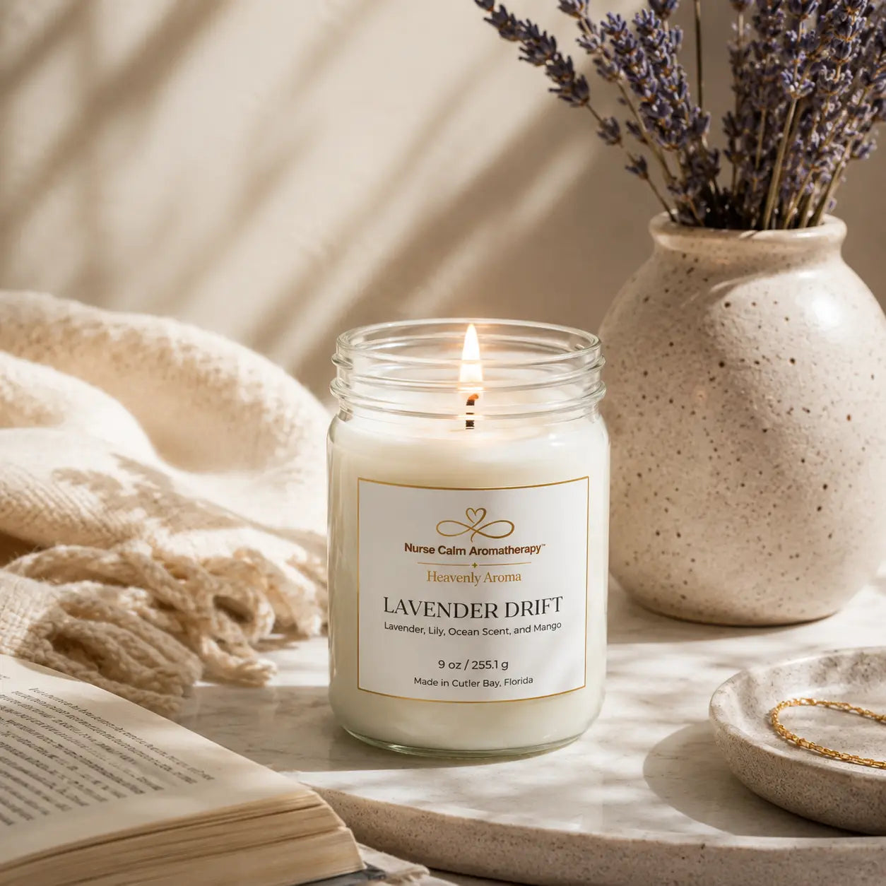 Lavender Drift candle surrounded by soft linens and lavender, creating a peaceful space for a daily reset ritual and intentional moments of calm.