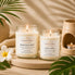 Tropical Escape Collection lifestyle photo featuring the One Love and Montego Bay luxury soy candles displayed in a warm tropical-inspired spa setting with palm leaves, soft candlelight, and neutral coastal décor.