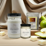Two jars of 'Apple Martini' candles with packaging and pears on a wooden surface.