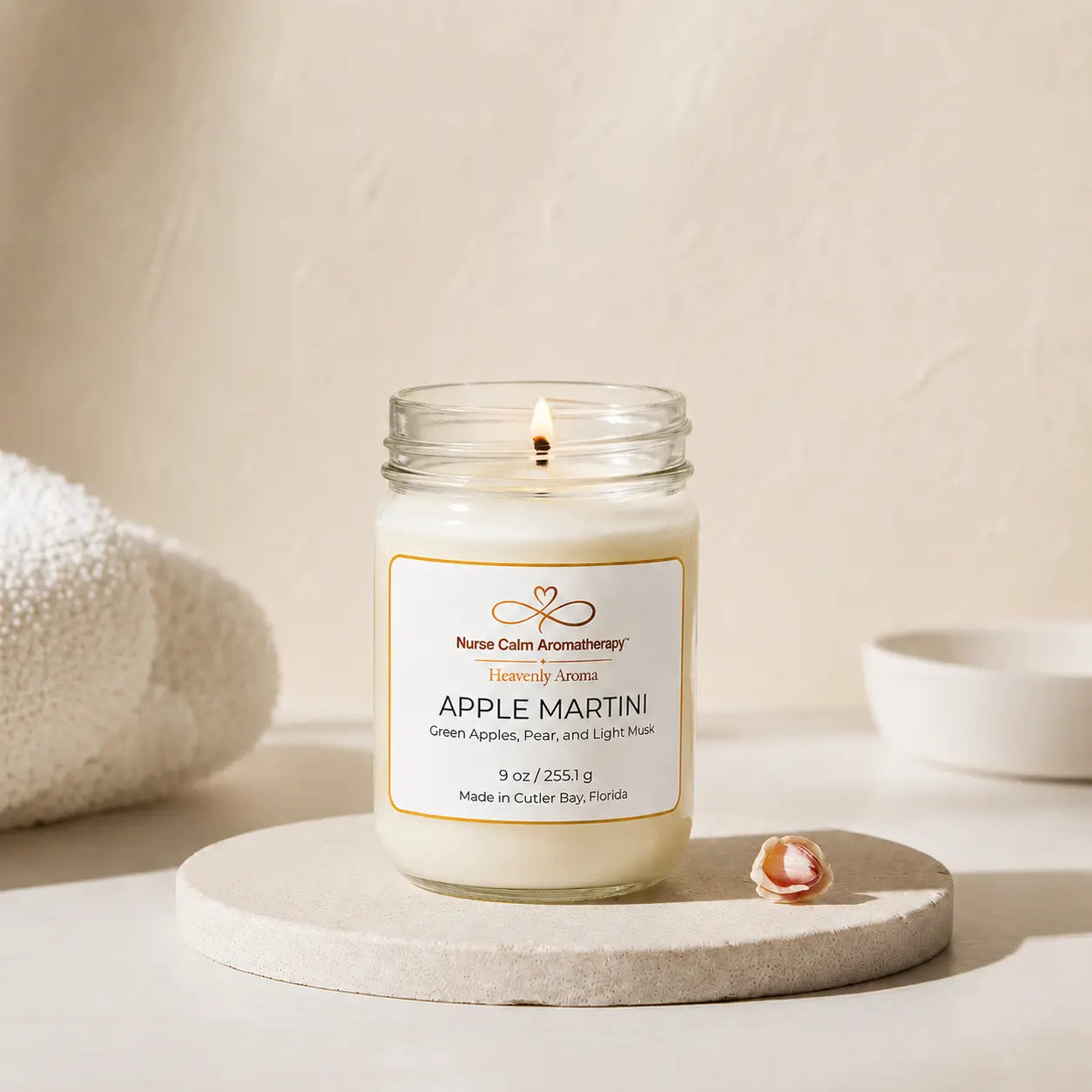 Candle in a glass jar with a label on a beige background