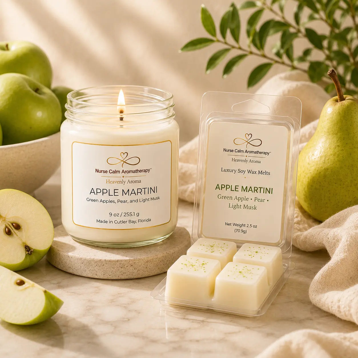 Apple Martini Signature Duo featuring a 9 oz handcrafted soy candle and Apple Martini luxury soy wax melt arranged on a luxury marble surface with green apples and pears.