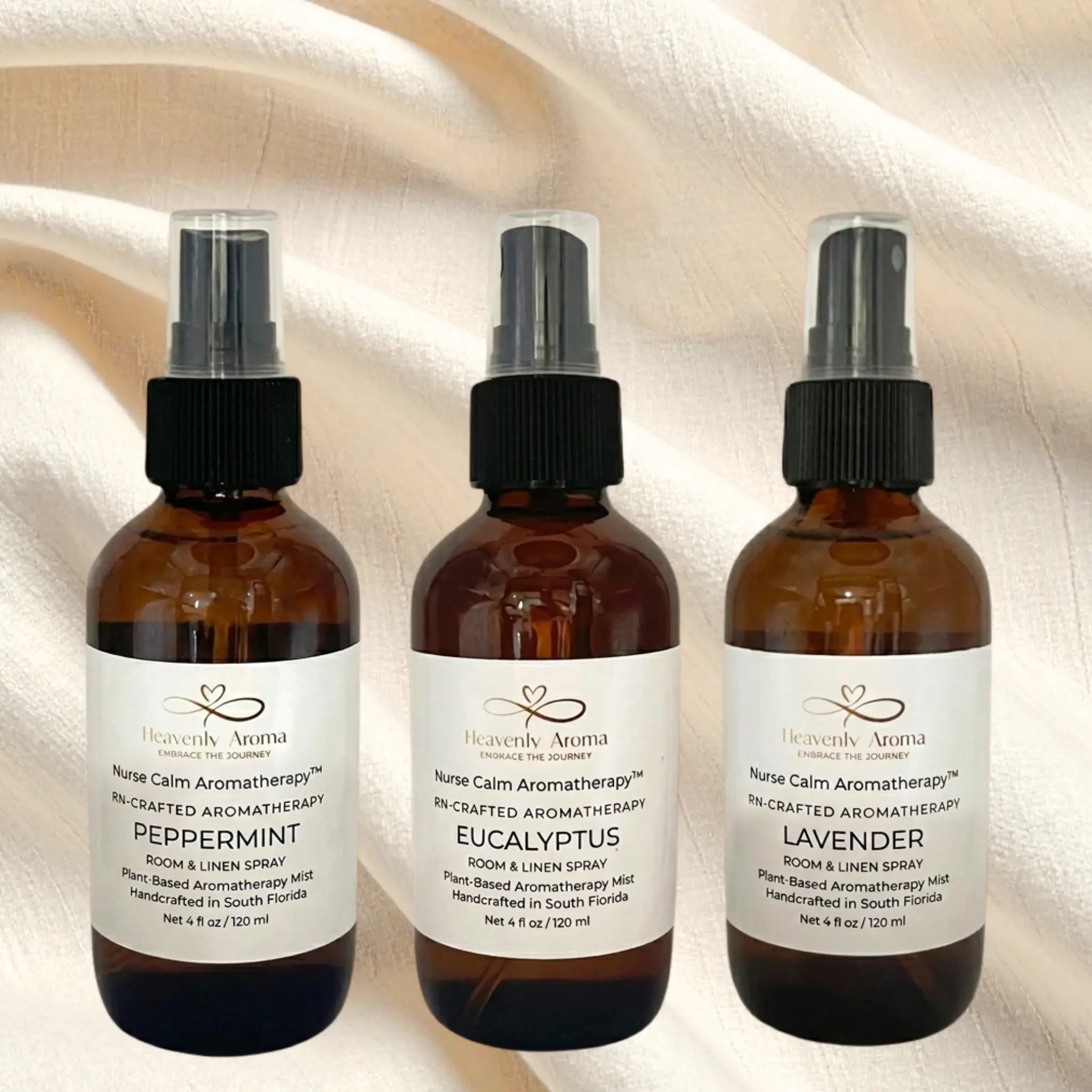 Three brown spray bottles with labels on a textured beige background