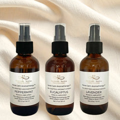 Three brown spray bottles with labels on a textured beige background