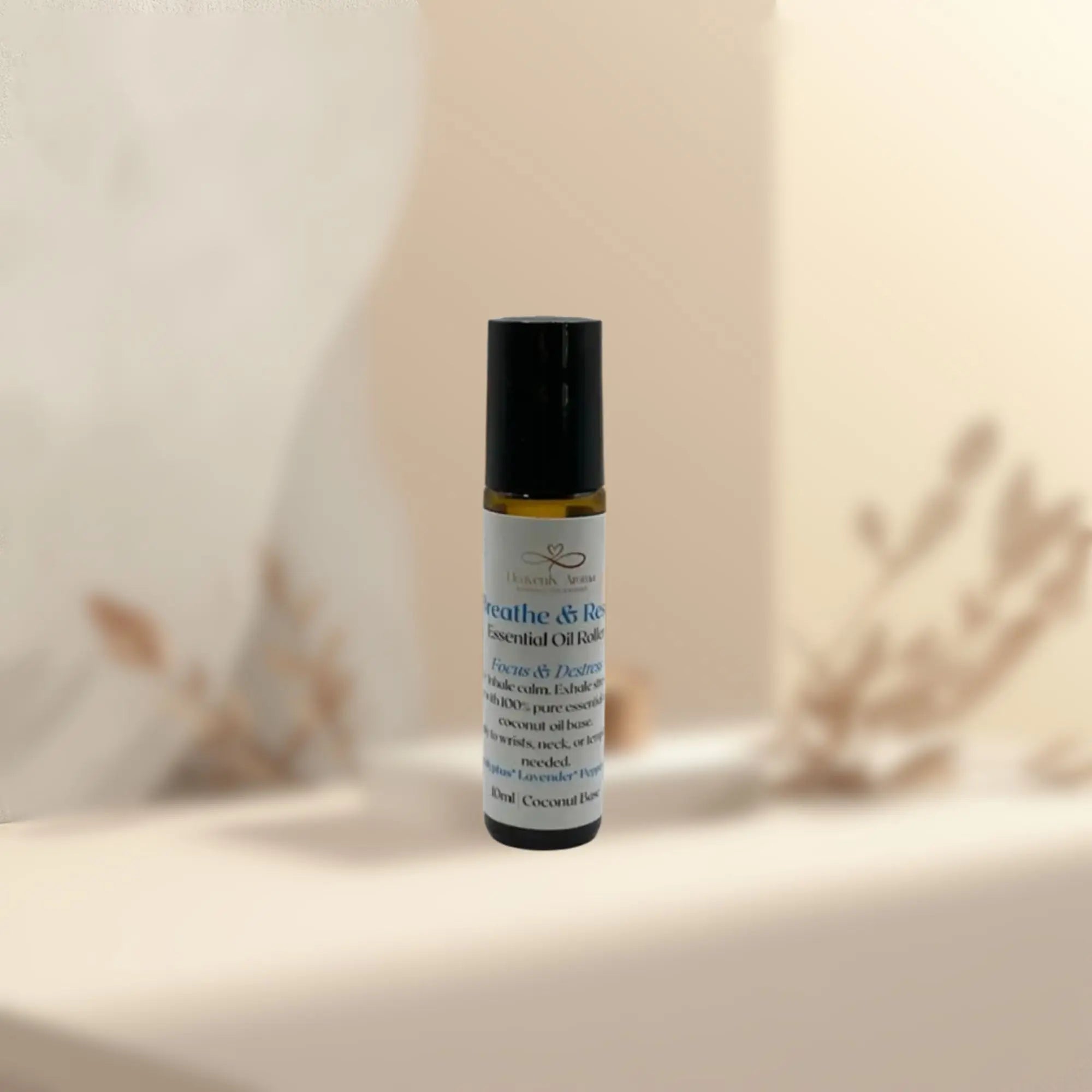 Roll-on bottle of essential oil blend on a neutral background