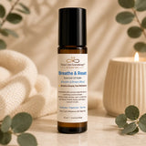 Close-up of Breathe & Reset Essential Oil Roller featuring eucalyptus, peppermint and tea tree in a 10 ml amber glass bottle.