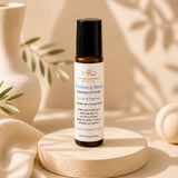 Essential oil roller bottle on a wooden stand with a neutral background