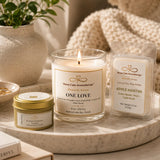 Candle and wax melts on a marble tray with a plant and books in the background