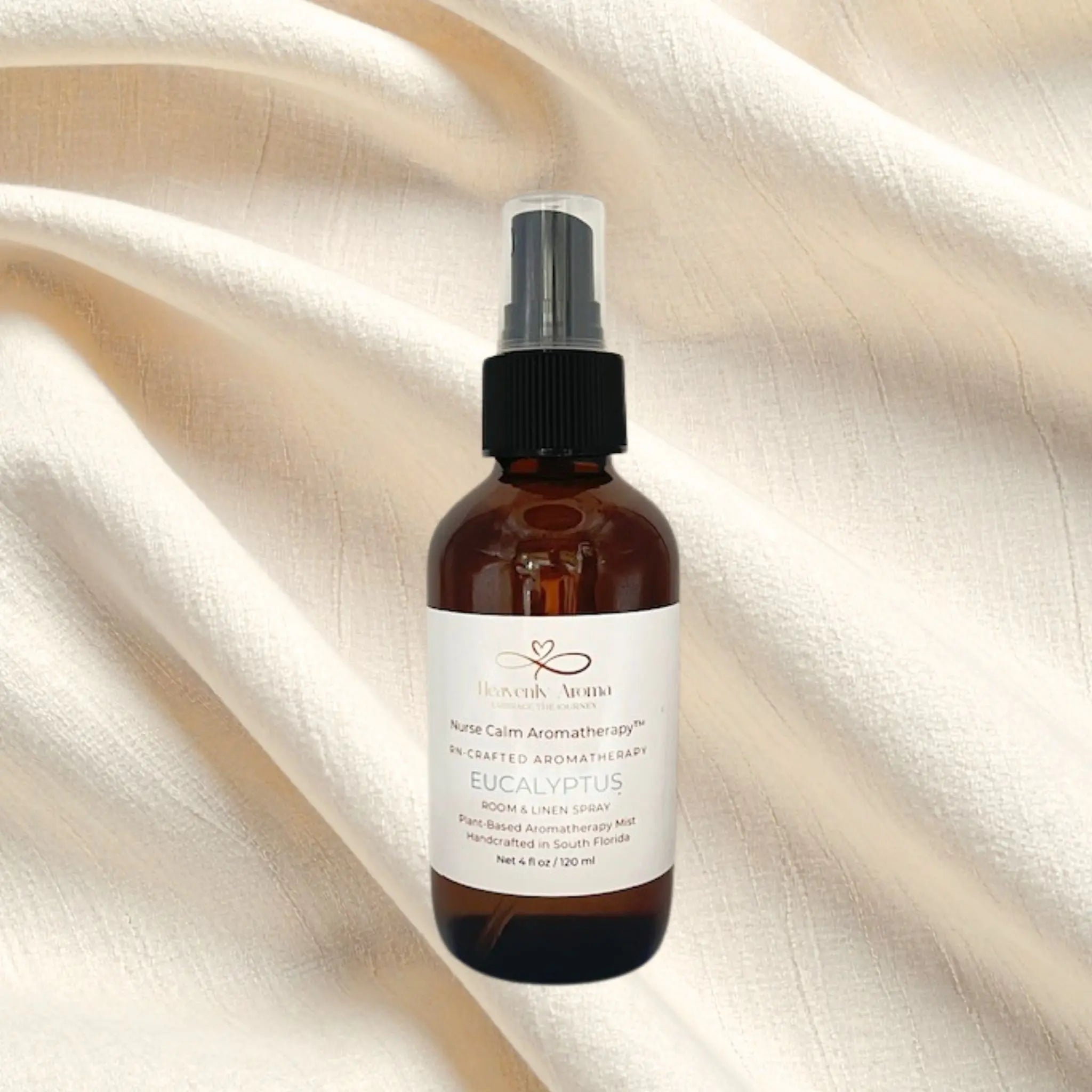 Brown spray bottle with a white label on a beige fabric background