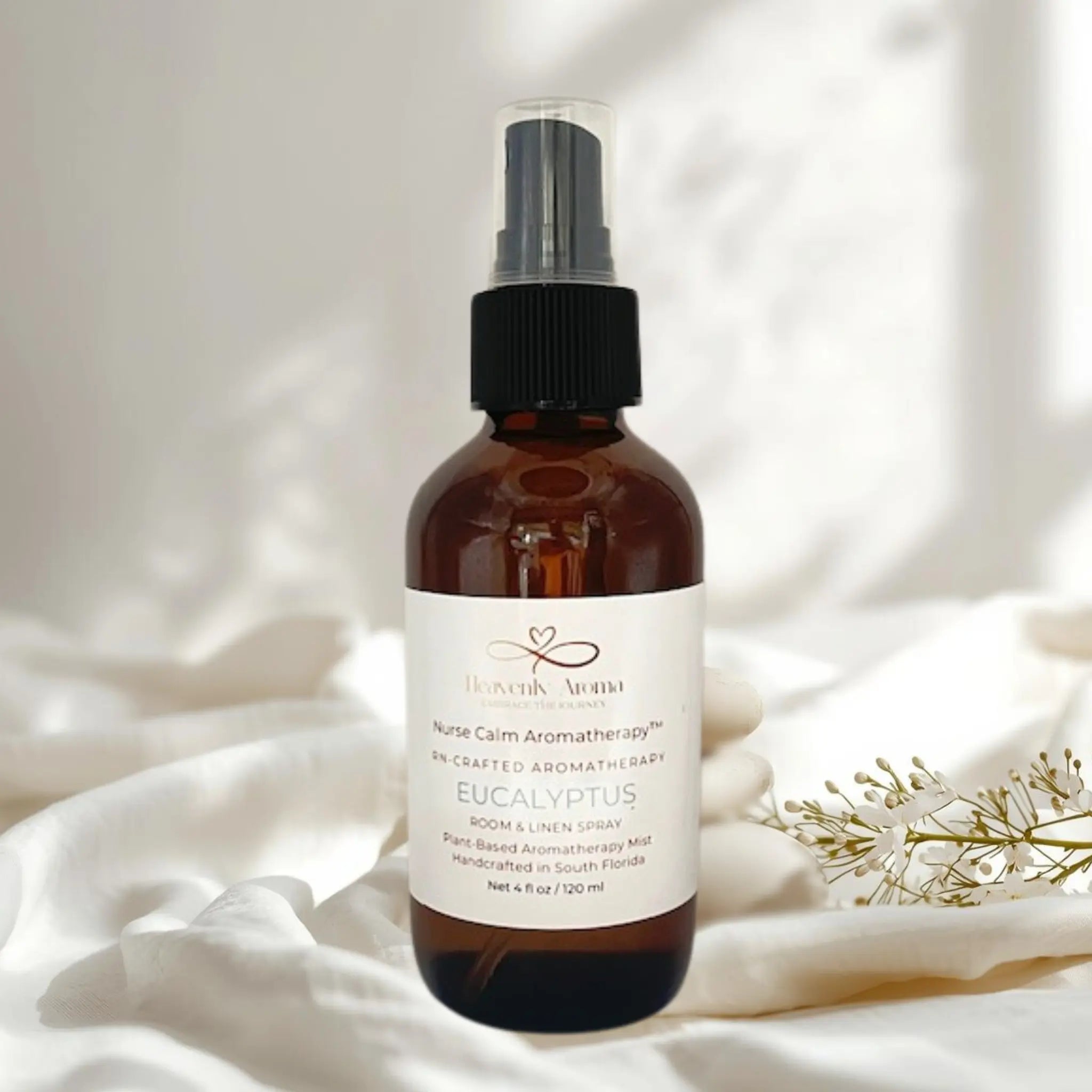 Brown spray bottle with a label on a white fabric background