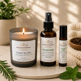 Close-up of the Focus & Energy Ritual bundle featuring Point Blank candle, Focus Fuel Room & Linen Spray, and Focus Fuel Essential Oil Roller.