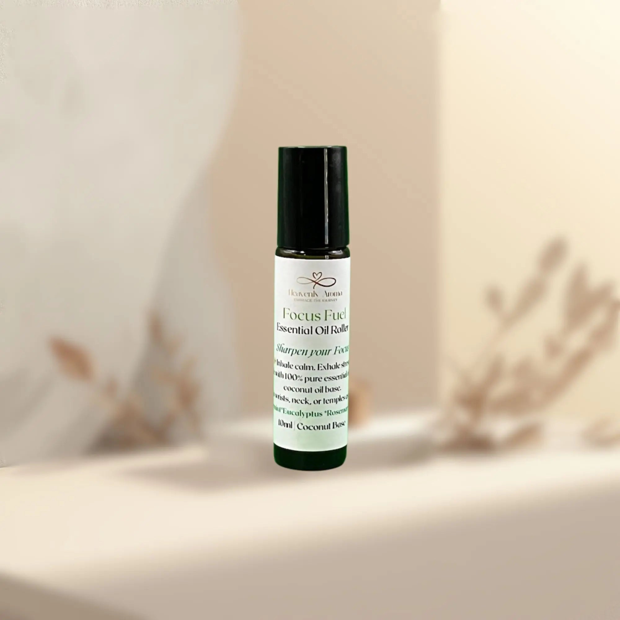 Roll-on bottle of FOCUS FUEL essential oil roller on a neutral background