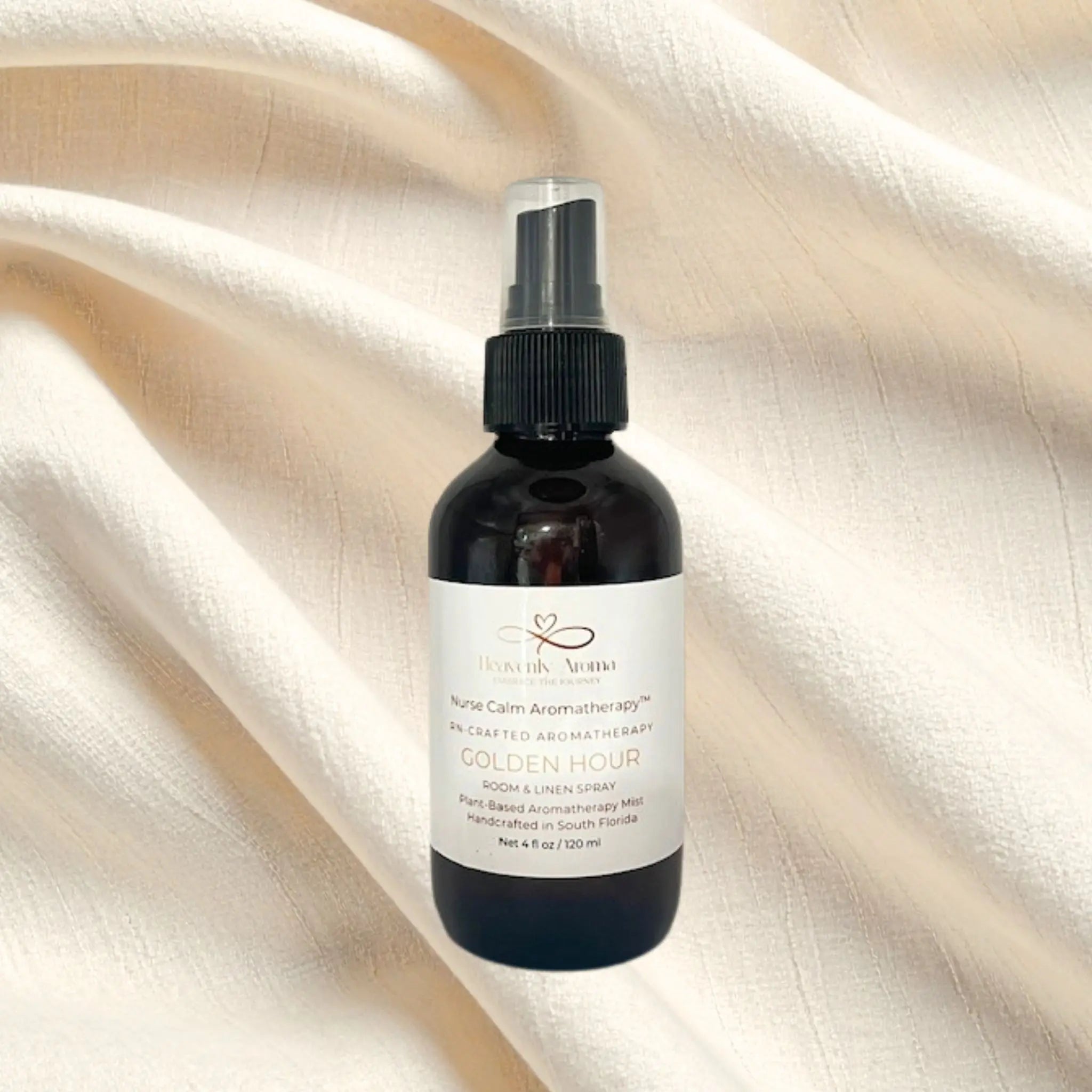 Black bottle with a white label on a beige fabric background