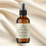 Brown bottle of Nurse Calm Aromatherapy™ by Heavenly Aroma Golden Hour aromatherapy spray on a beige fabric background