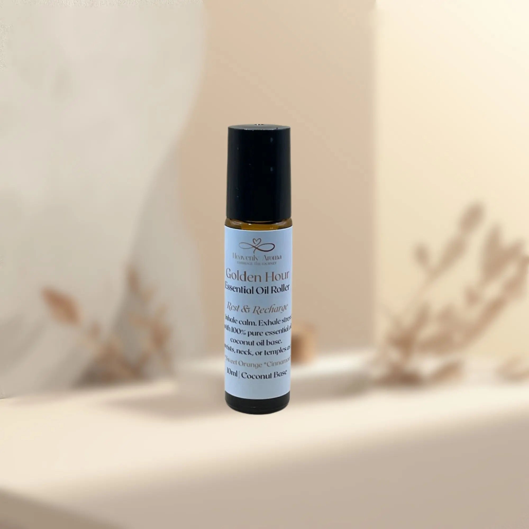 Roll-on bottle of Golden Hour essential oil blend on a neutral background