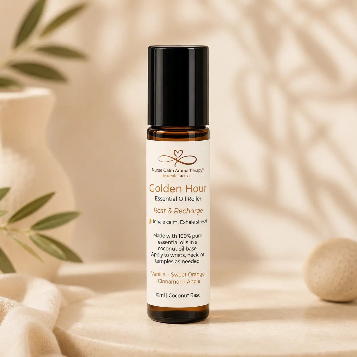 Essential oil roller bottle labeled 'Golden Hour' on a neutral background with plants.
