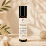 Essential oil roller bottle labeled 'Golden Hour' on a neutral background with plants.