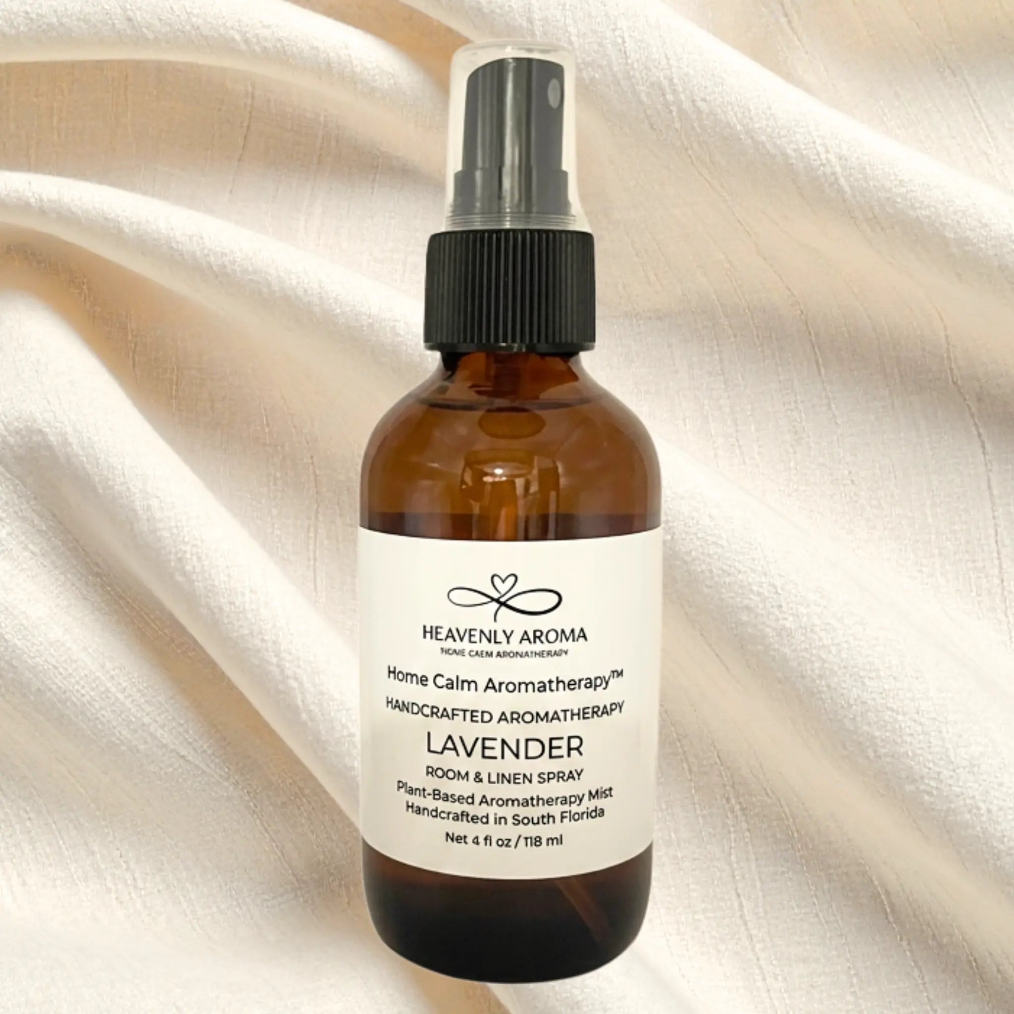 Brown spray bottle with a label on a beige fabric background