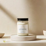 Candle labeled 'Lavender Drift' on a beige surface with a neutral background