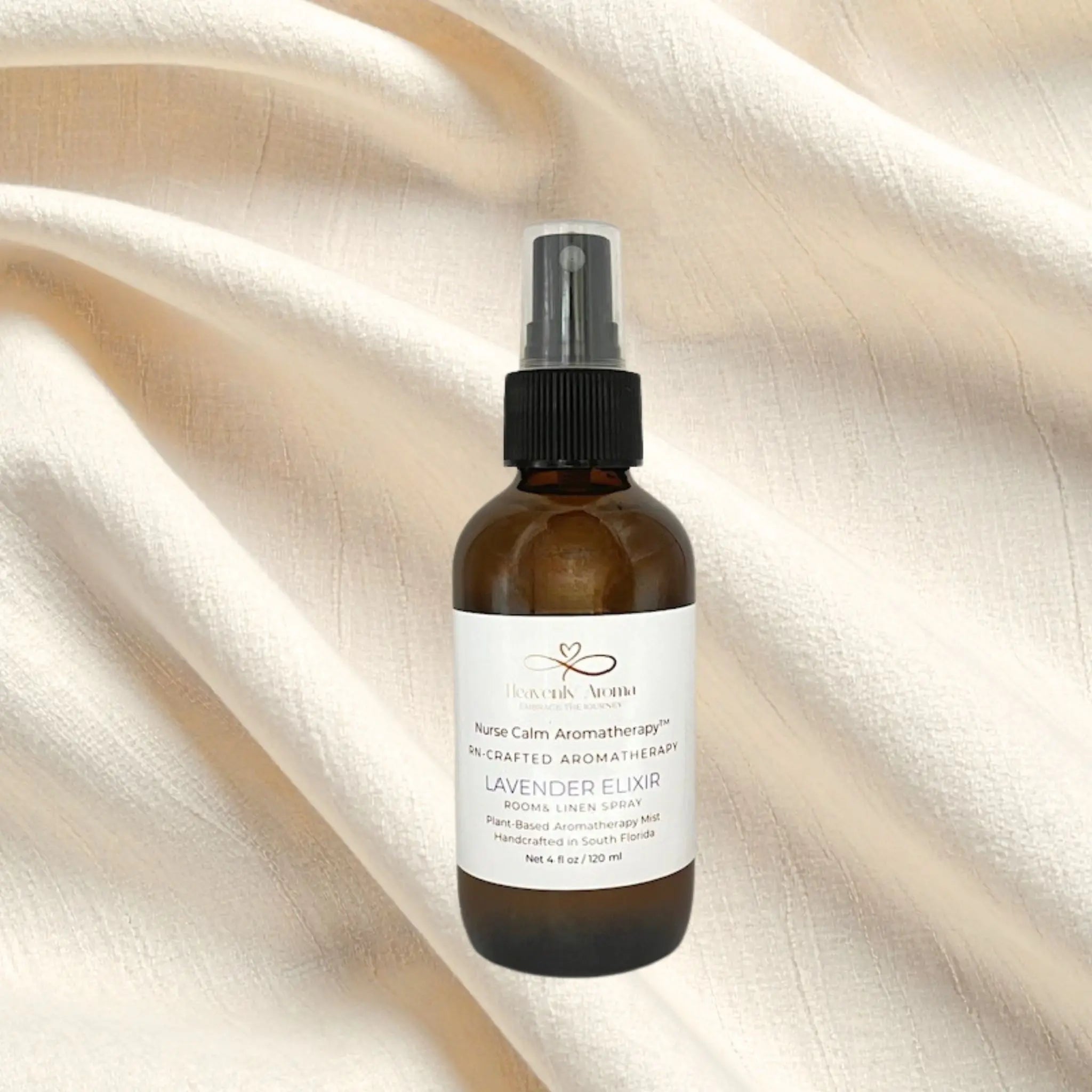 Brown spray bottle with a label on a beige fabric background