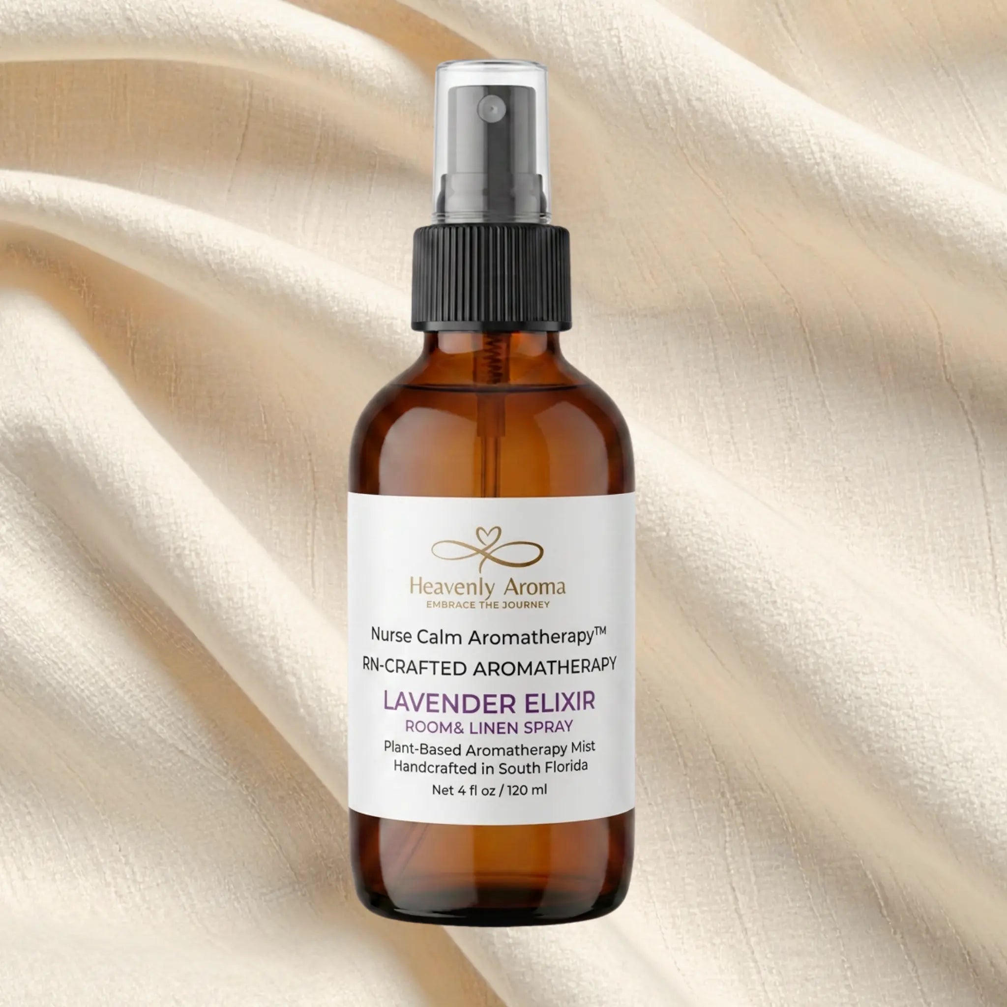 Brown bottle of Heavenly Aroma Lavender Elixir on a beige fabric background