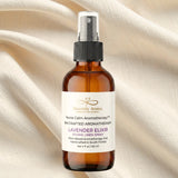 Aromatherapy spray bottle labeled 'Heavenly Aroma' on a beige fabric background