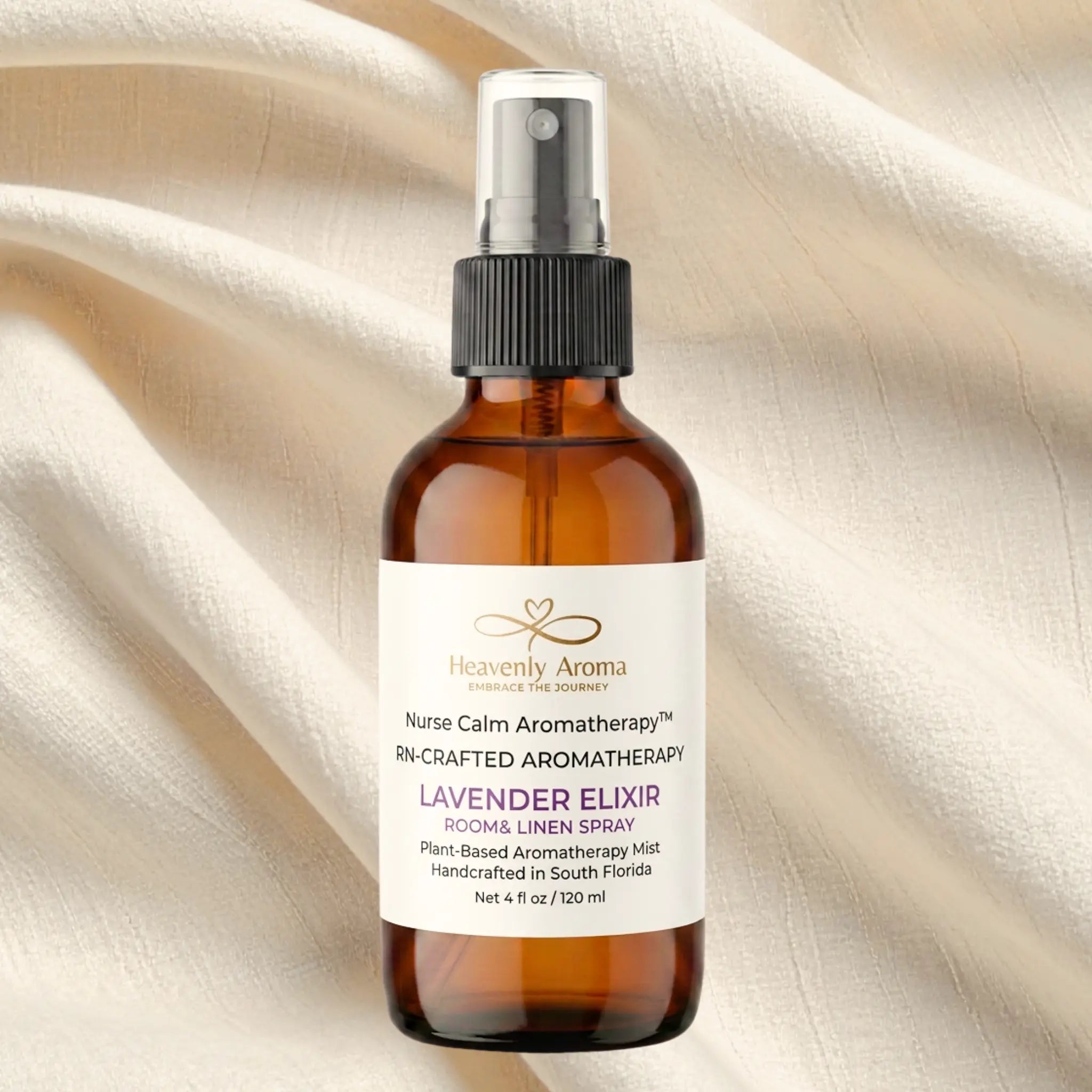 Aromatherapy spray bottle labeled 'Heavenly Aroma' on a beige fabric background
