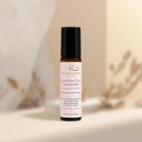 Roll-on bottle of Lavender Elixir essential oil on a neutral background