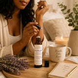 Lavender Elixir Essential Oil Roller beside cozy wellness essentials creating a peaceful self-care environment.