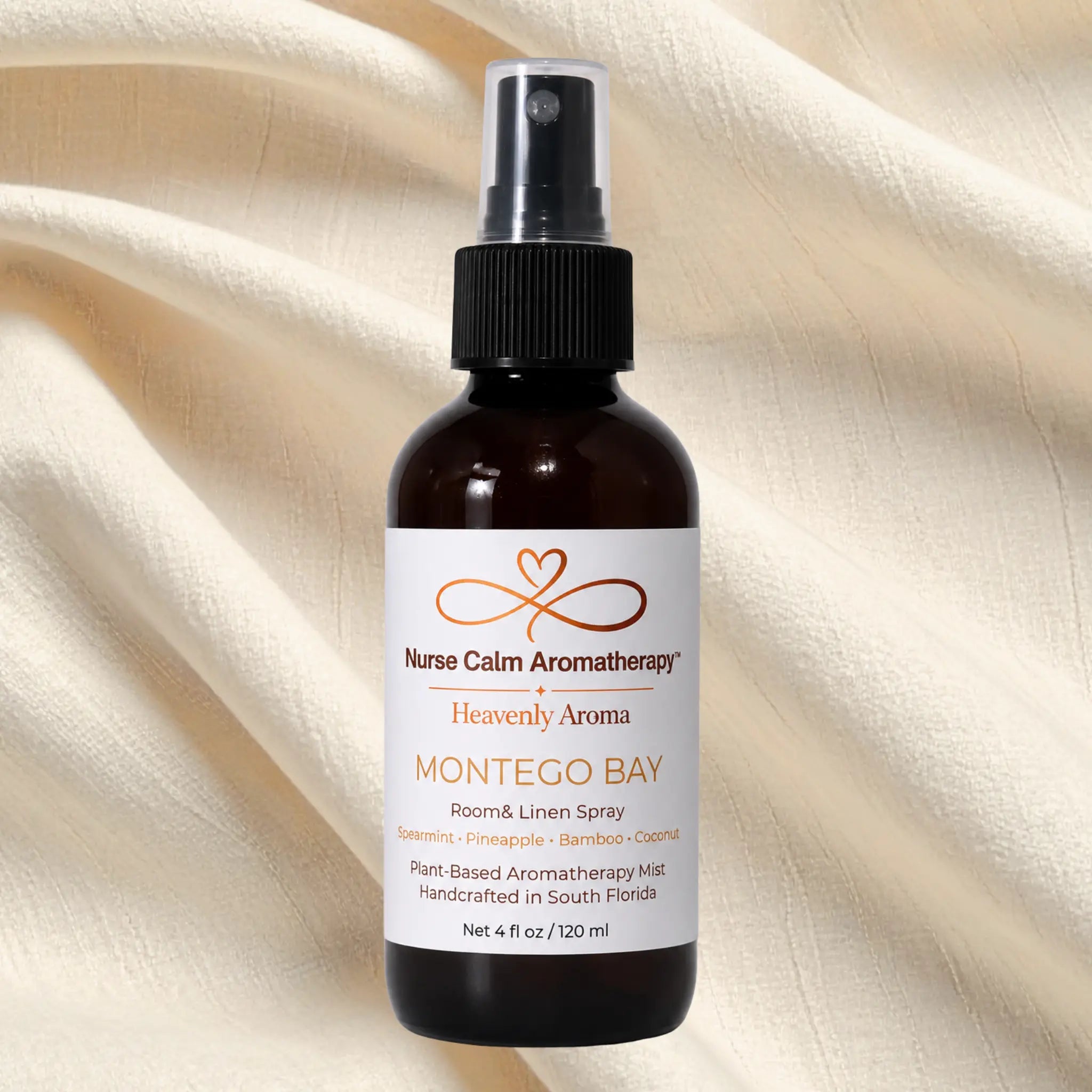 Nurse Calm Aromatherapy Montego Bay room & linen spray bottle on a beige fabric background