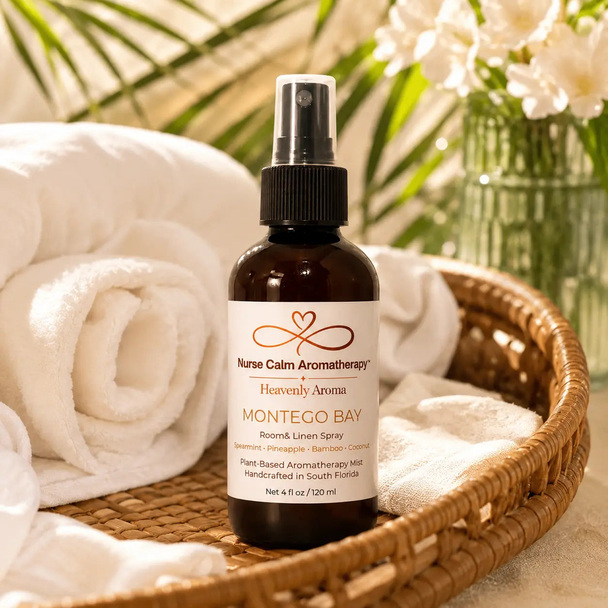 Nurse Calm Aromatherapy bottle on a woven tray with towels and flowers in the background