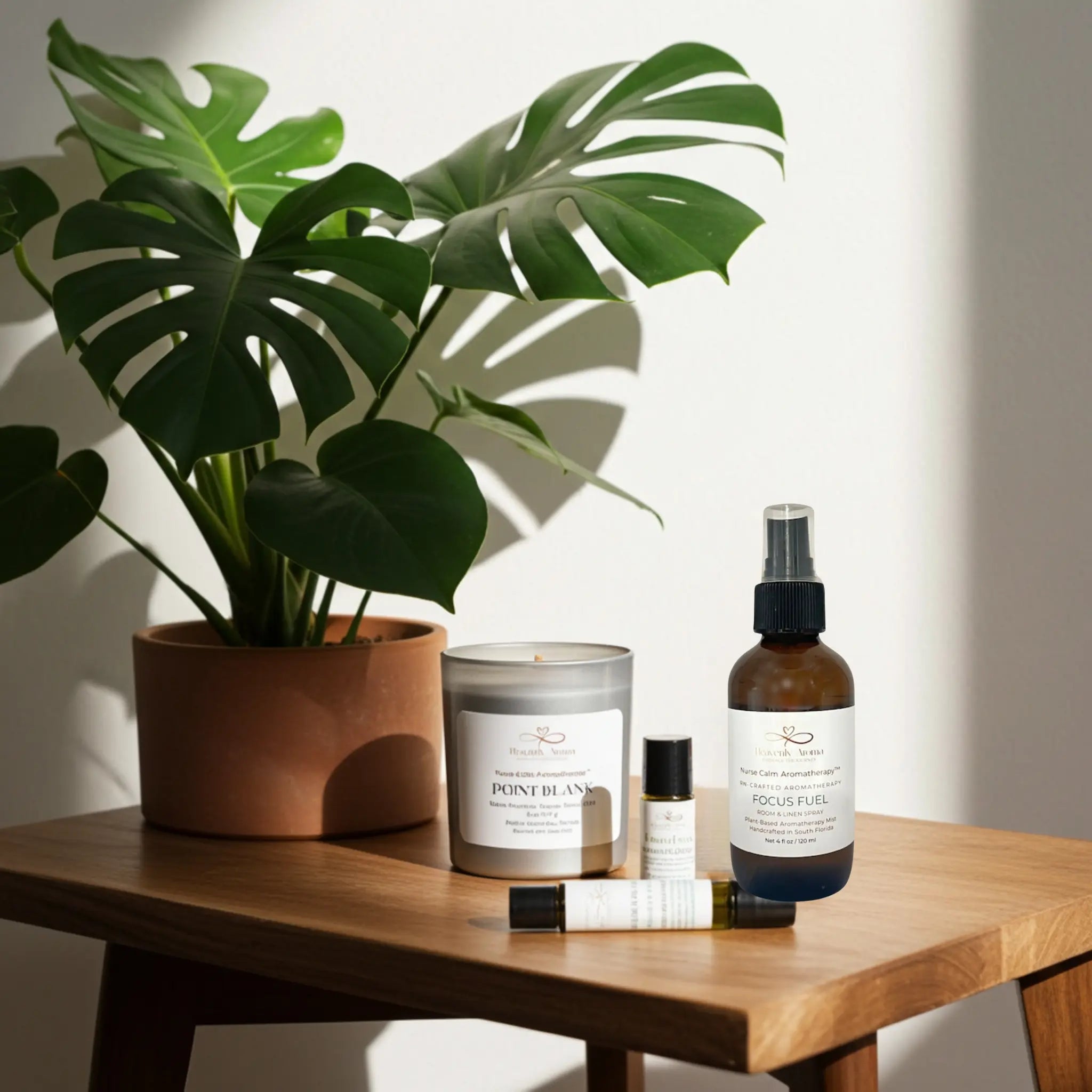 Table with a potted plant, candles, and skincare products on a neutral background