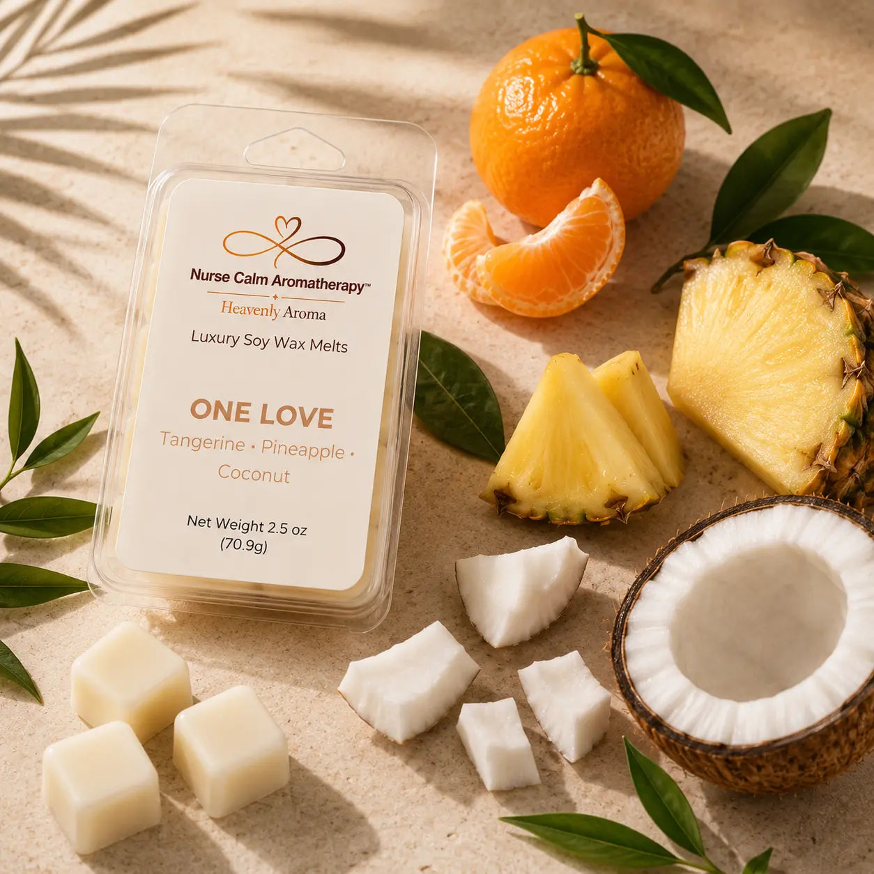 Flat lay featuring fresh tangerines, pineapple, coconut, and tropical botanicals representing the fragrance inspiration for One Love.