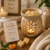 One Love Luxury Soy Wax Melts melting in a ceramic wax warmer, filling the home with uplifting tropical citrus fragrance.