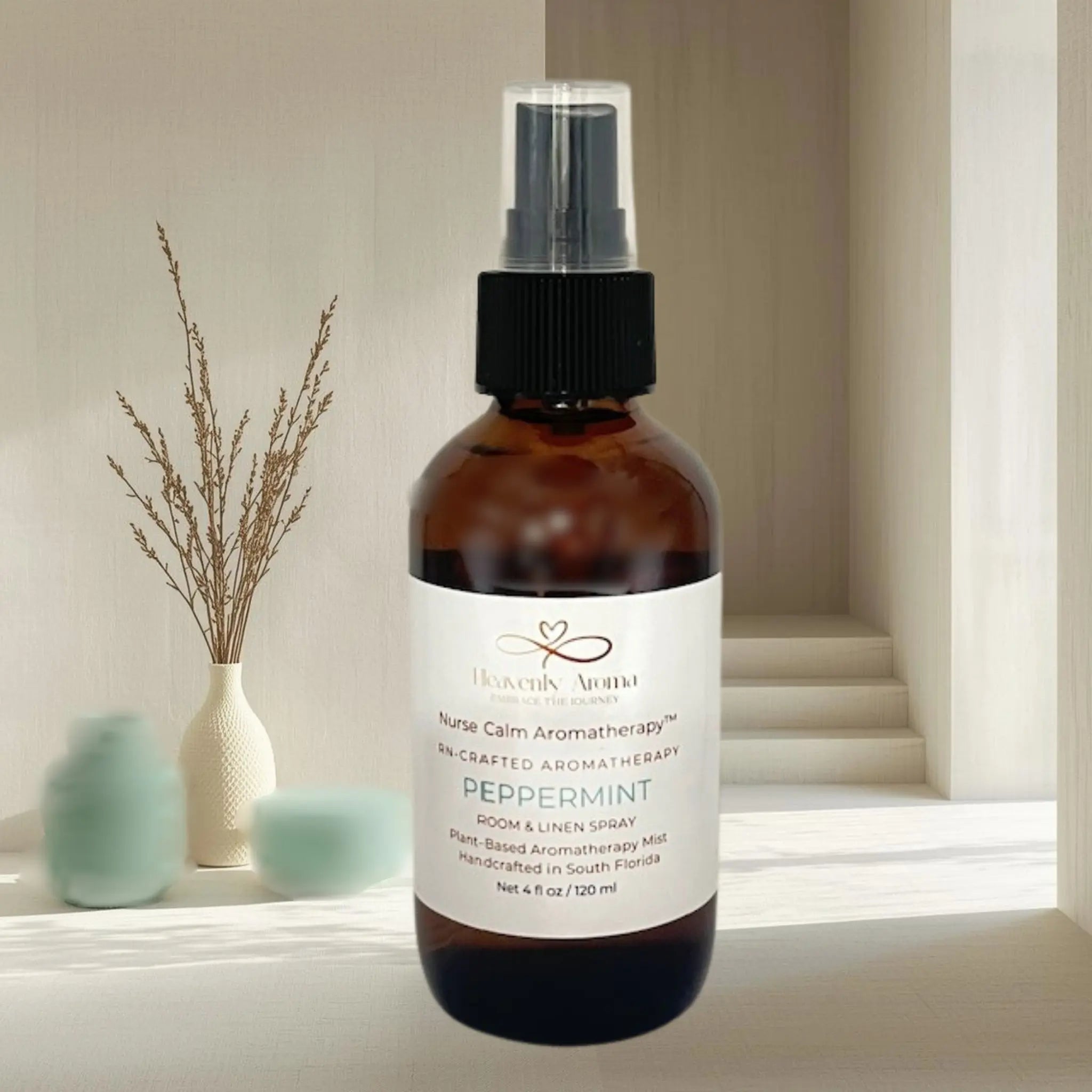 Brown spray bottle with a label on a windowsill with decorative items.