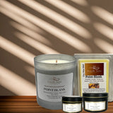 Candle and wax melts with labels on a wooden surface with a shadowy background