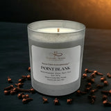 Aromatherapy candle with clove buds on a dark surface