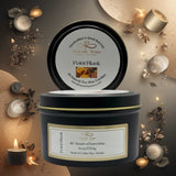 Black candle jar with 'Heavenly Aroma' label surrounded by decorative candles and elements on a warm-toned background.