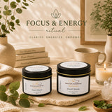 Two candles labeled 'Point Blank' on a table with plants and books in the background, featuring the text 'Focus & Energy ritual'.