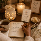 Point Blank Luxury Soy Wax Melts displayed during a calming Reset Ritual with journaling, candlelight, a ceramic wax warmer, and peaceful surroundings.