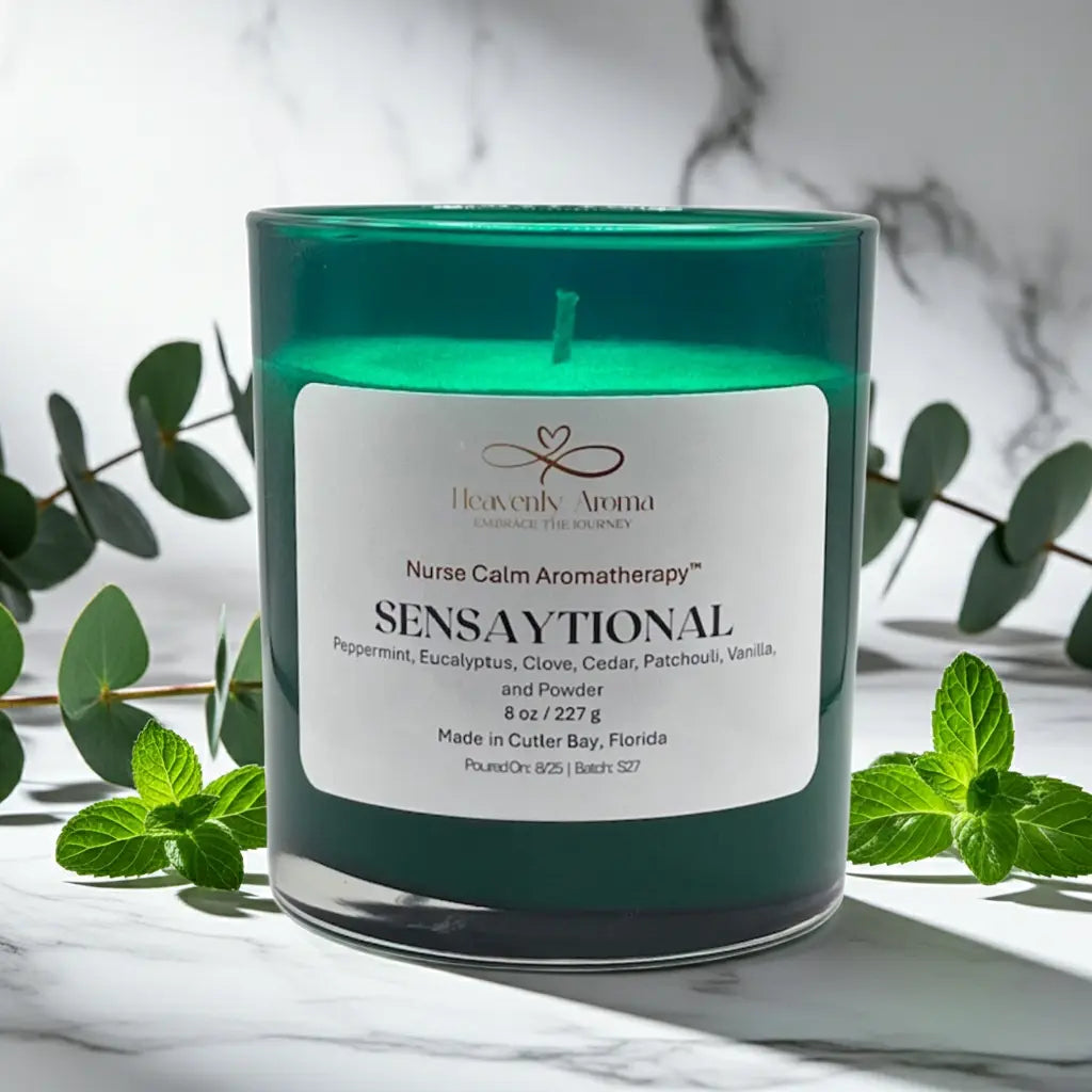 Green candle with a label on a marble surface with green leaves