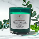 Green candle with a label on a white background with green leaves