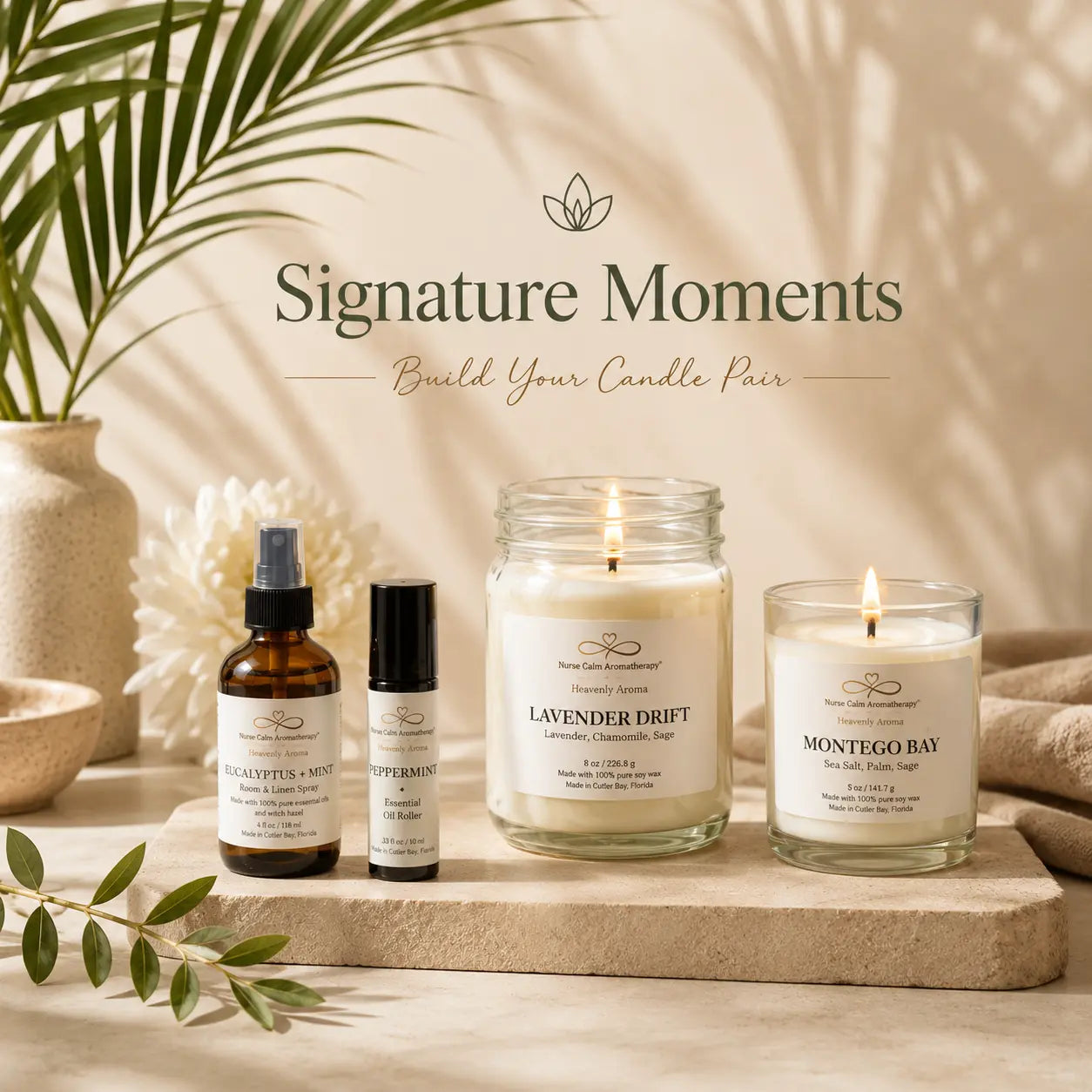 Three candles and two bottles on a wooden surface with 'Signature Moments' branding.