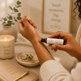 Person applying Sunset Escape Essential Oil Roller to the wrists for a tropical aromatherapy escape.