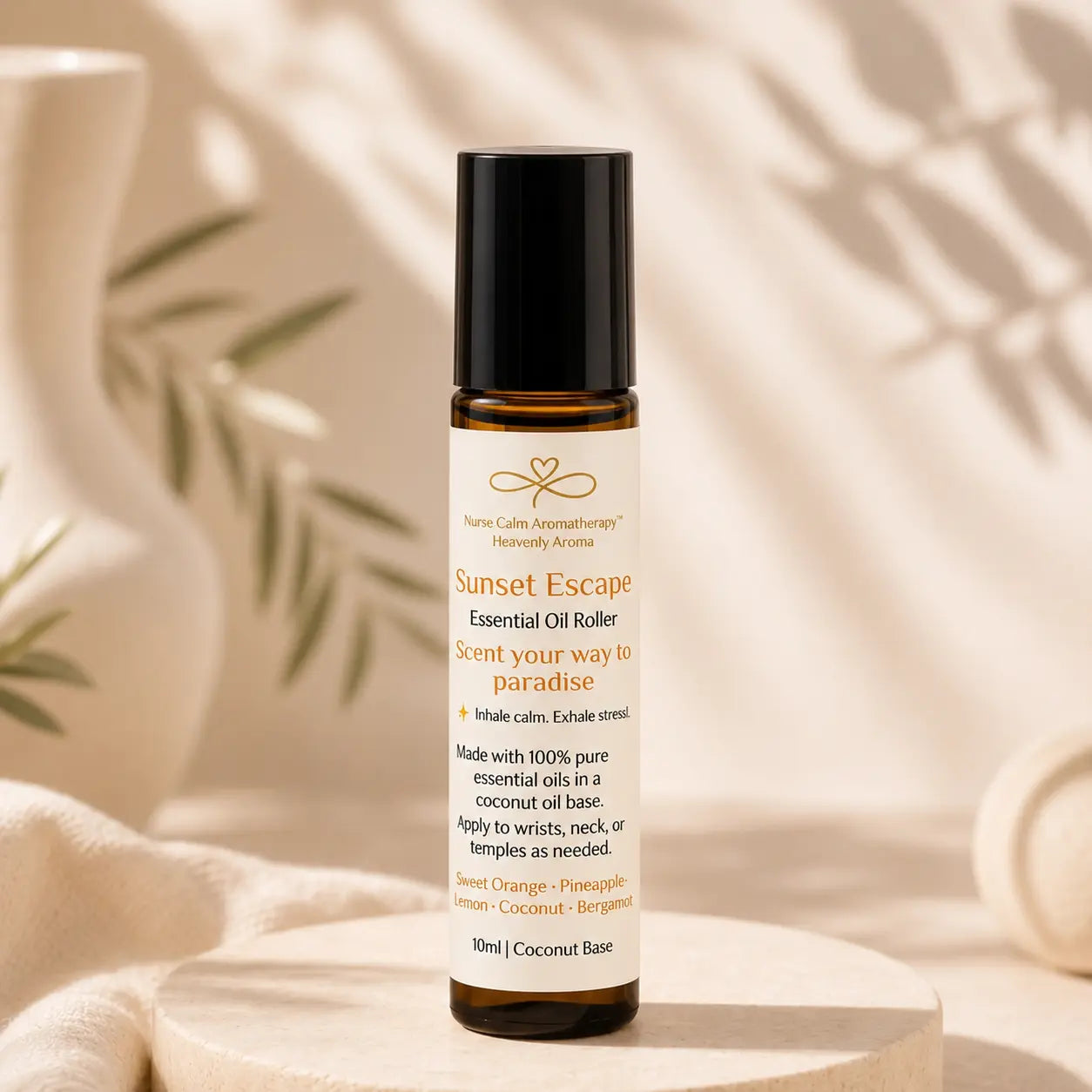 A 10ml amber glass essential oil roller bottle with a black cap and cream label, reading 'Sunset Escape' by Nurturist Aromatherapy, styled on a wooden pedestal with soft leaf shadows.