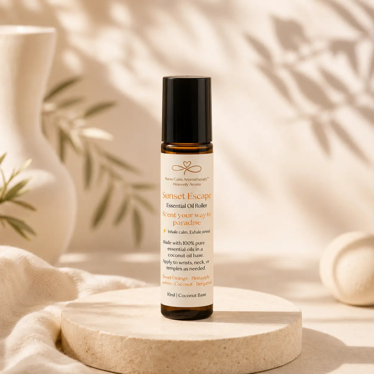 Roll-on bottle of 'Sunset Escape' essential oil roller on a beige background with leaves.