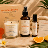 Tropical Escape bundle contents including One Love soy candle, Sunset Escape Room & Linen Spray, and Sunset Escape Essential Oil Roller.