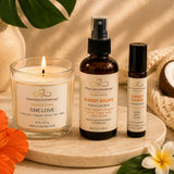 Close-up of the Tropical Escape bundle featuring One Love candle, Sunset Escape Room & Linen Spray, and Sunset Escape Essential Oil Roller.